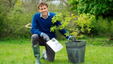 Pictured: HiPP UK's marketing director Richard Walker planting the scheme's first tree, an oak, at the National Trust's Runnymede site in Surrey